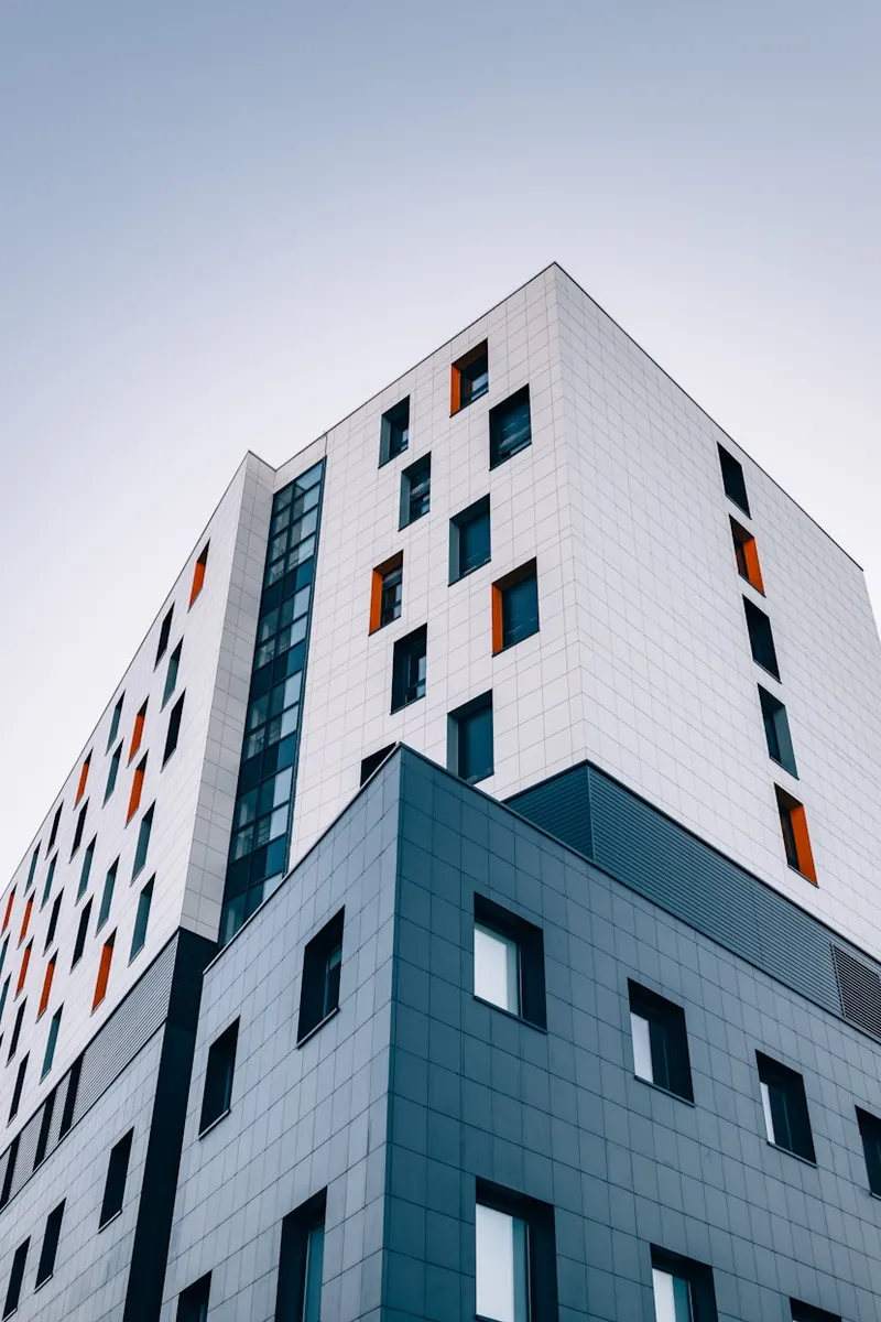 Low-angle view of a modern high-rise building's tiled facade