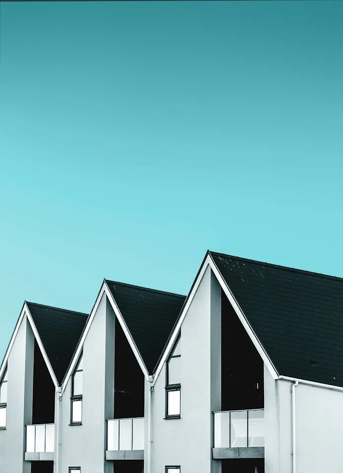 Row of gabled rooftops against a blue sky