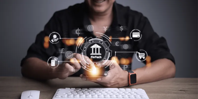 Hand holding a smartphone with a digital fintech icon overlay