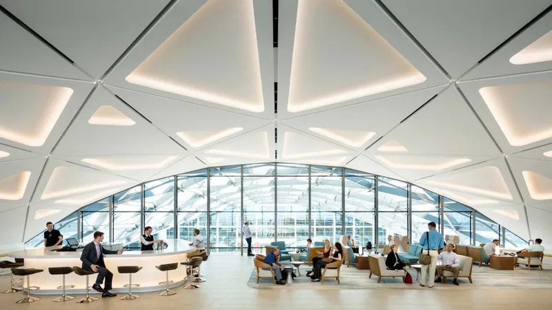 Modern lounge interior with a high vaulted ceiling and seating areas
