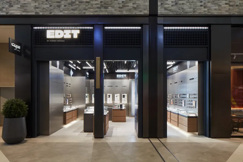 EDIT by Ahmed Seddiqi storefront with illuminated signage and watch displays