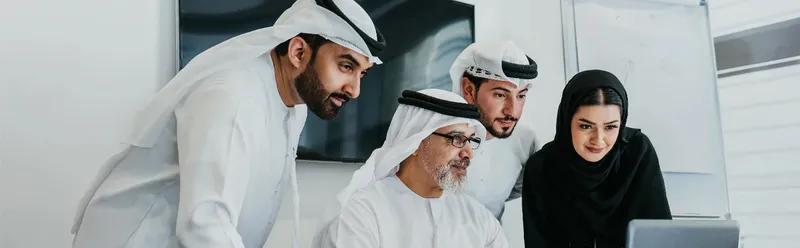 Team reviewing a dashboard together on a laptop in an office