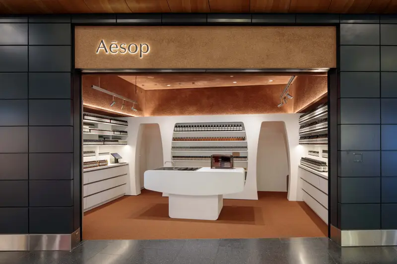 Aesop store entrance with shelves of product bottles