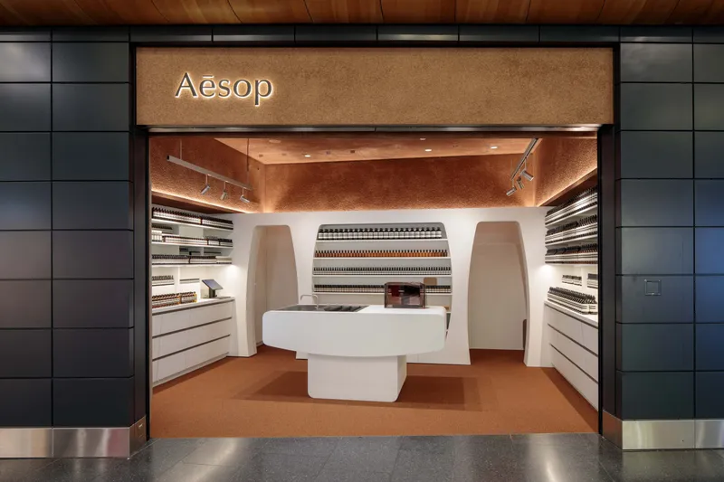 Aesop store entrance with shelves of product bottles