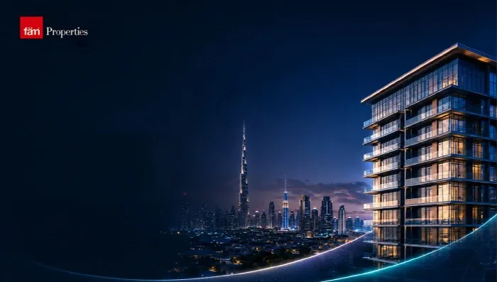 Dubai skyline with the Burj Khalifa at night beside a fäm Properties residential tower