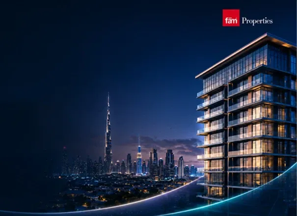 Dubai skyline with the Burj Khalifa at night beside a fäm Properties residential tower
